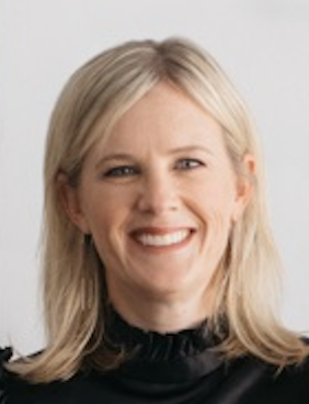 A smiling woman with blonde hair wearing a black top, set against a neutral background.